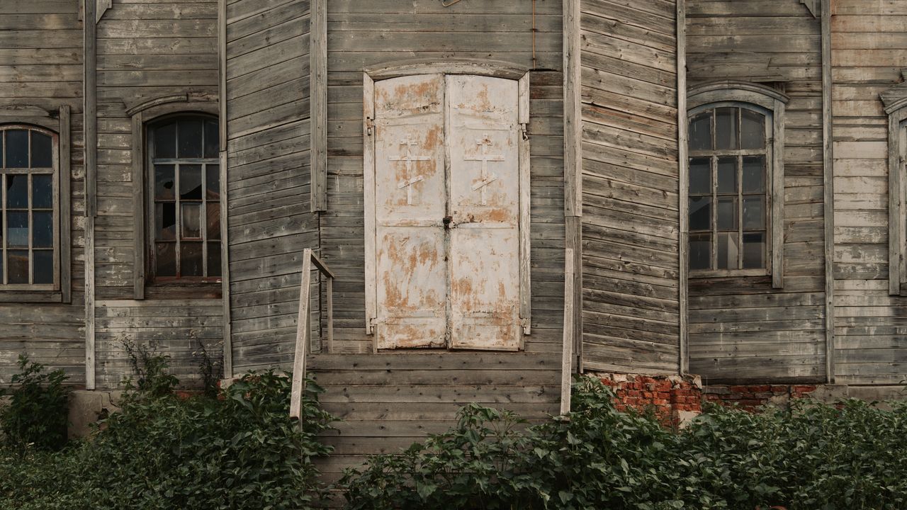 close up of an abandoned wooden church with rustic texture and old doo