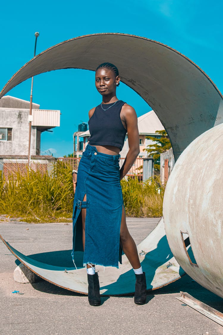 Woman Standing In Denim Skirt