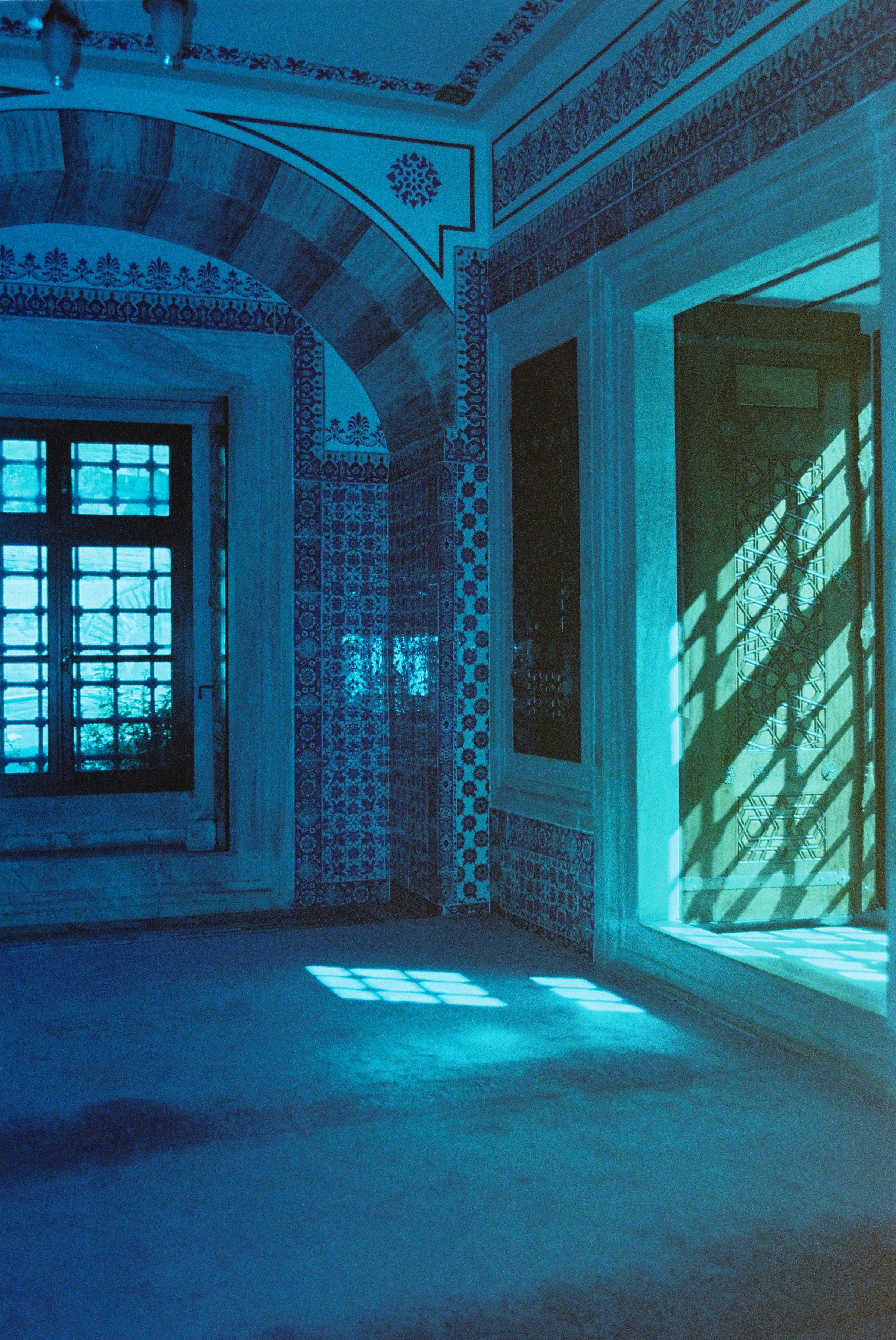 Capture of a sunlit interior with blue tint in a traditional Istanbul mosque.