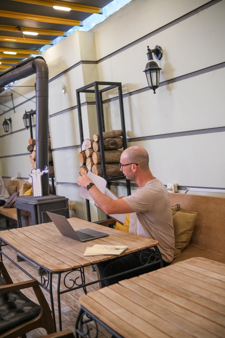 Man Working With Laptop At Cafe