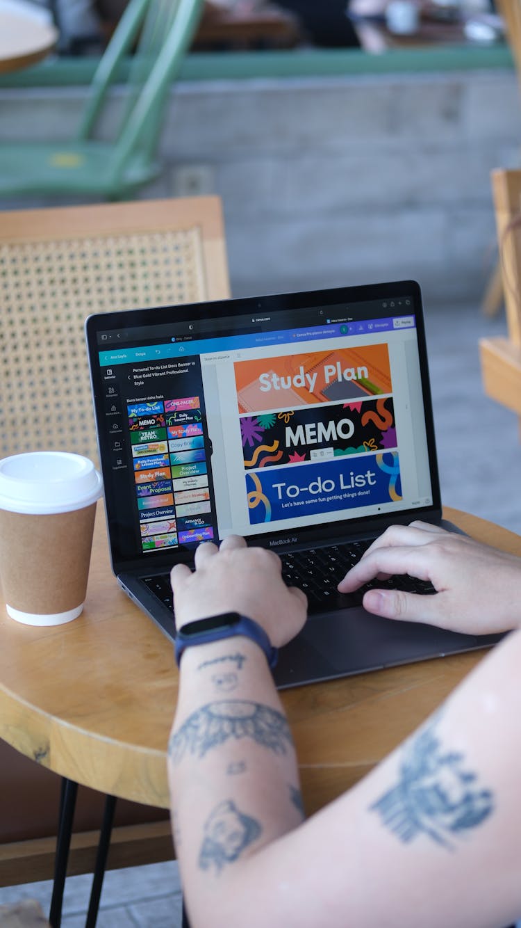 Woman Sitting At Cafe And Using Graphic Software