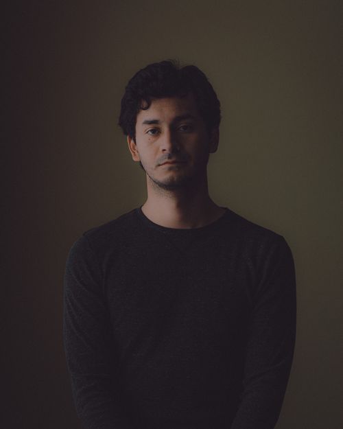 Free Artistic portrait of a man in a black sweater with a moody and dramatic atmosphere. Stock Photo