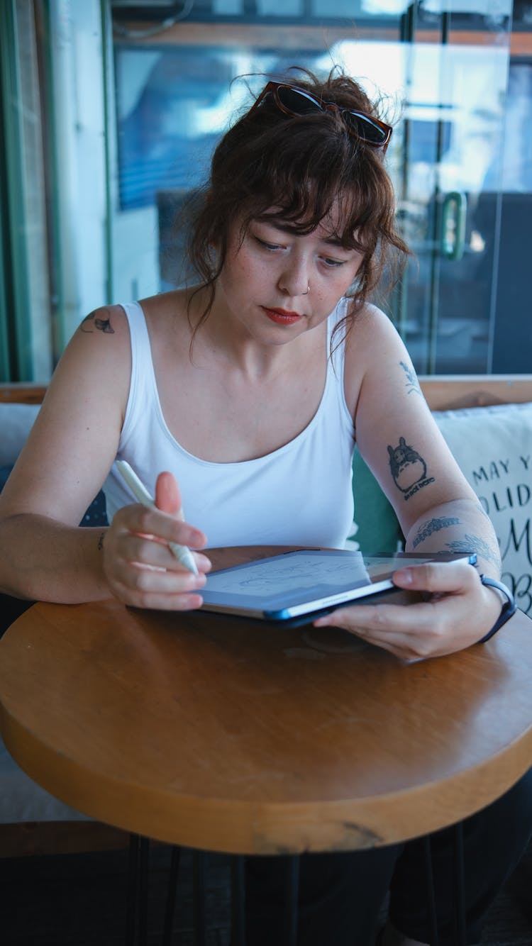 Woman Working On Tablet In A Restaurant 