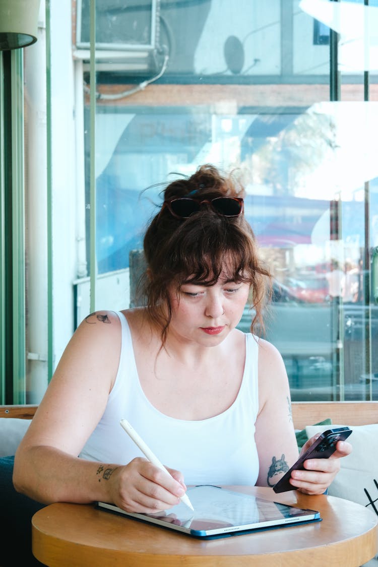 Woman Sitting With Cellphone And Devices