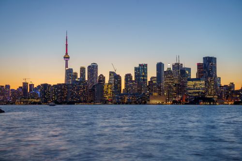 Free Stunning Toronto skyline with CN Tower at sunset, viewed across Lake Ontario. Stock Photo