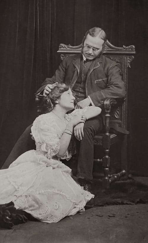Old Photograph of a Young Woman Sitting at Her Father Feet
