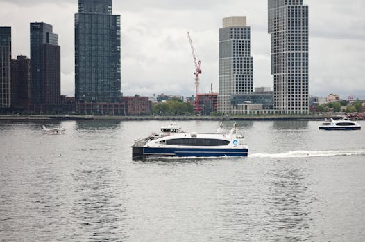 Urban rainy river scene with boats, skyscrapers, and a seaplane in New York City.