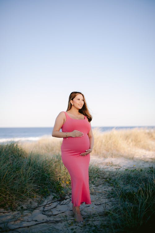 Pregnant Woman Posing in Pink Dress