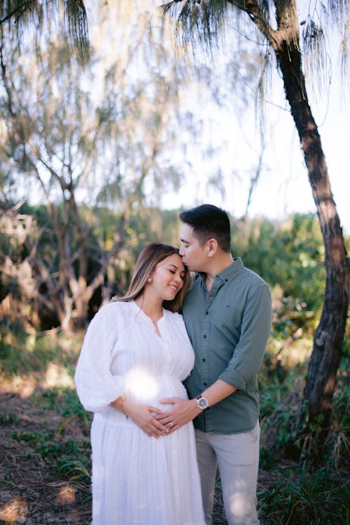 Man Kissing Pregnant Woman