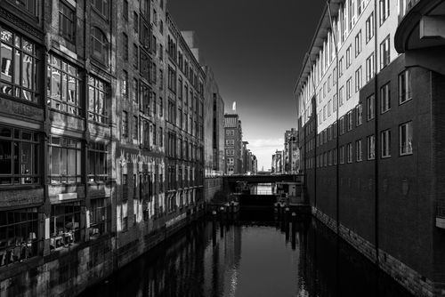 Free Black and white photo of canal and historic buildings in Hamburg's Speicherstadt. Stock Photo