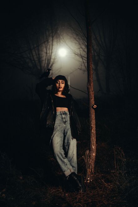 Woman in a foggy night forest under a lamp, photo by Wolrider YURTSEVEN on Pexels