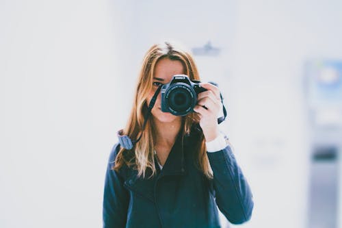 Blonde Woman Taking Pictures with Camera