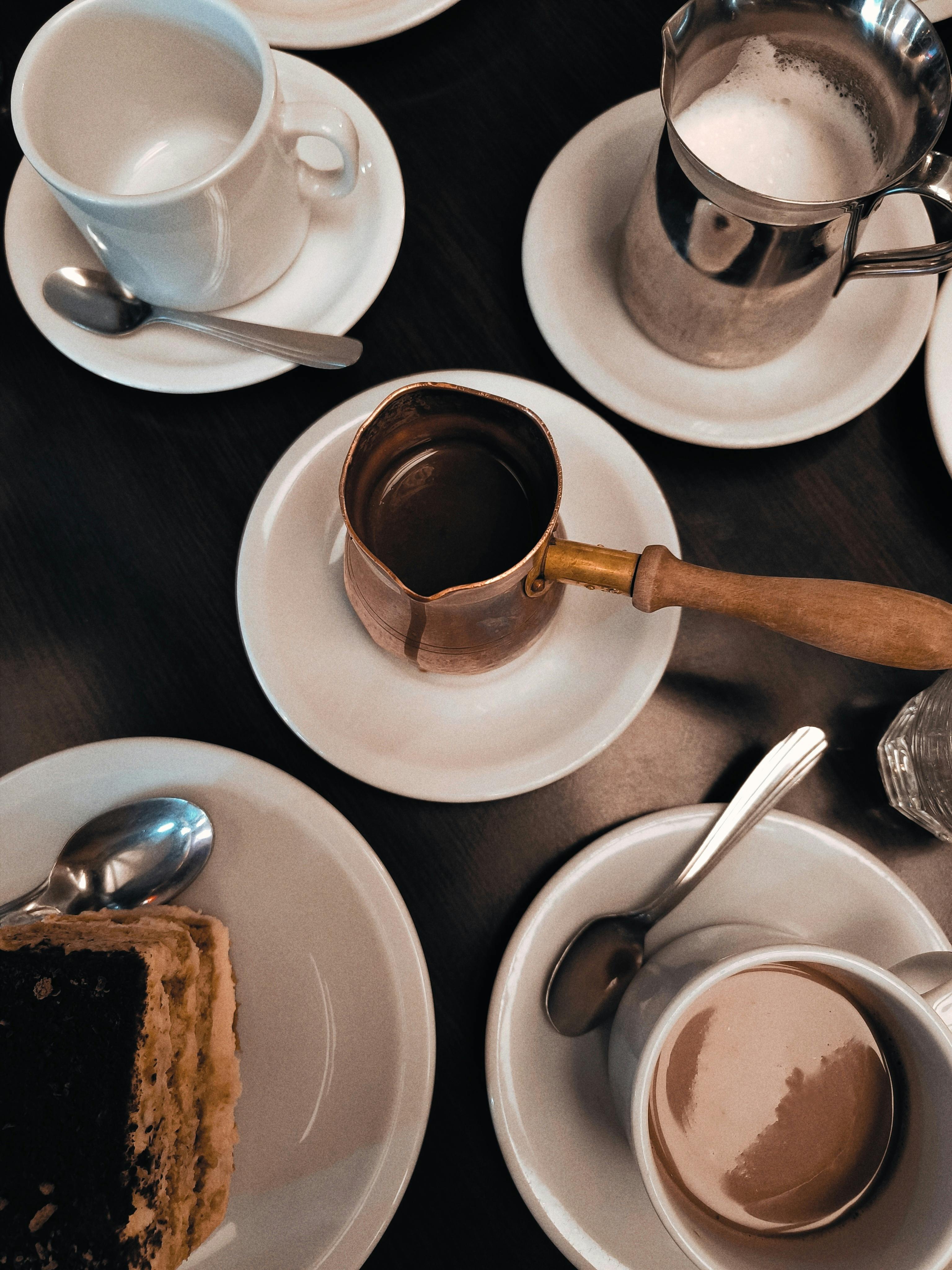 A sophisticated coffee table setup with cups, saucers, and a slice of cake in Buenos Aires, Argentina.