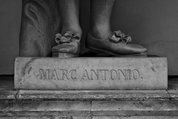 Close Up Of Text Under Marc Antonio Sculpture