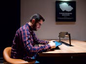Man Sitting with Tablet at Desk