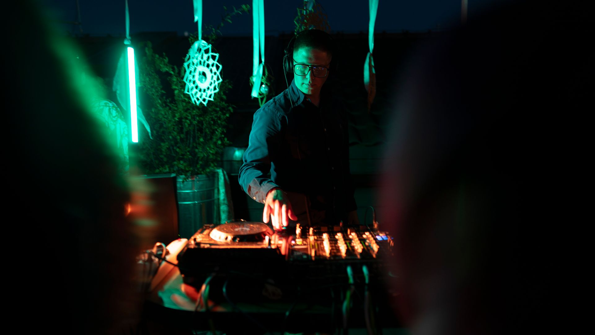 A DJ performs at a vibrant nightclub event in Lviv, featuring dynamic lighting and music.