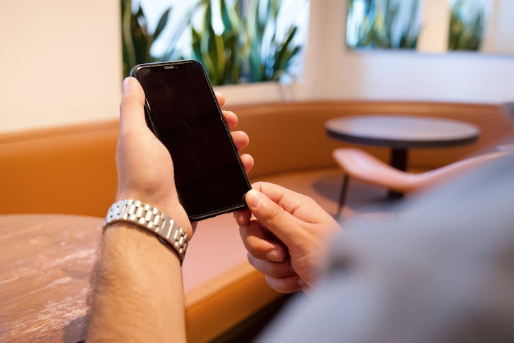 Man Using Phone In A Restaurant