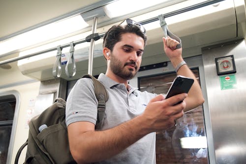 Man Using his Phone in the Subway