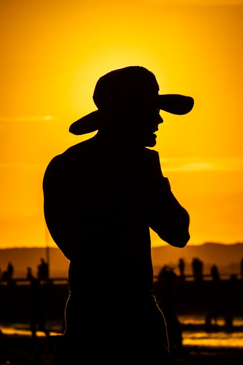 Standing Man in Hat at Sunset