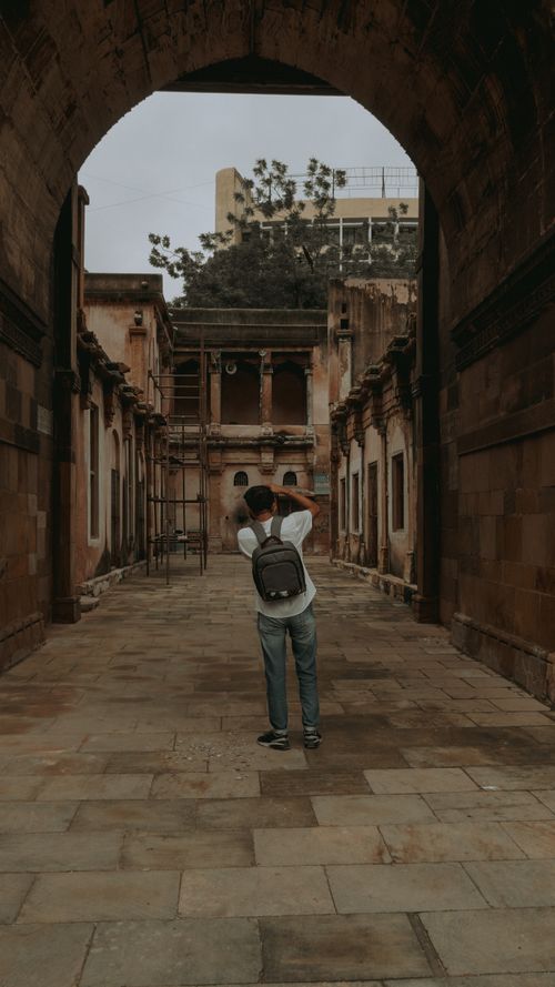 Free A young tourist stands in a historic street in Ahmedabad, capturing the essence of the old city. Stock Photo