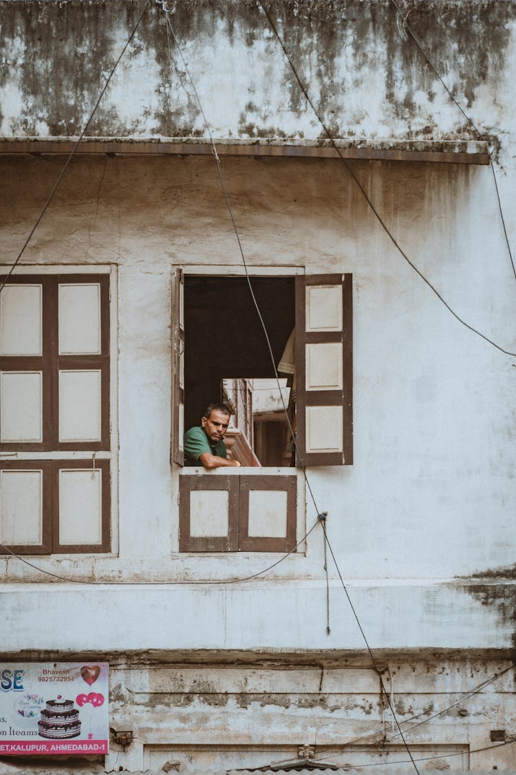 Man Looking Out Window