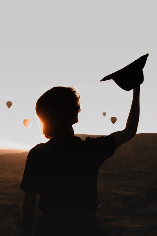 Silhouette of Man against Hot Air Balloons Floating in Cappadocia