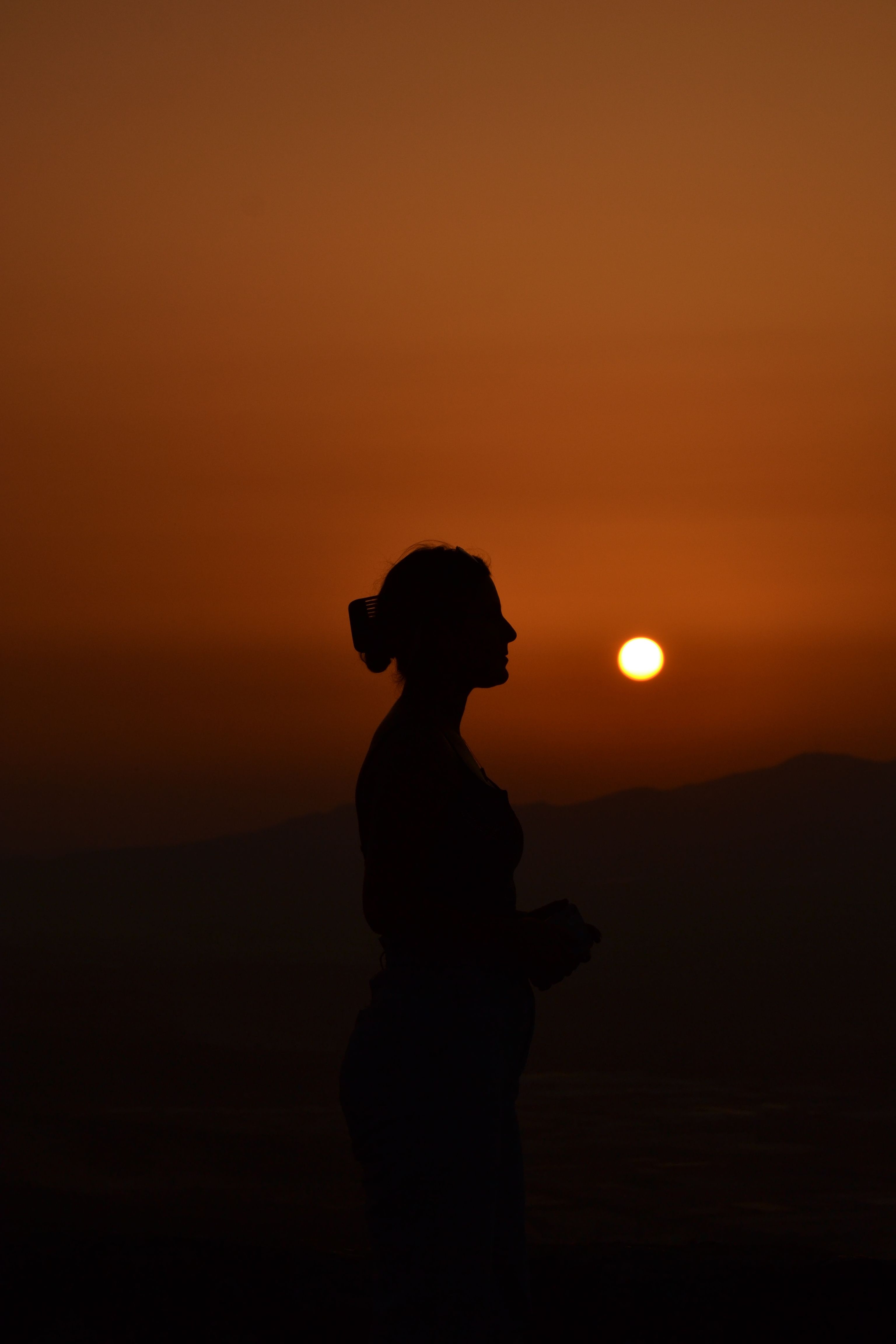 Silhouette of Woman at Sunset · Free Stock Photo