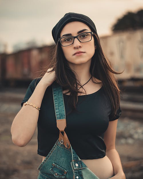 Woman Wearing Black Crop Top And Blue Overalls