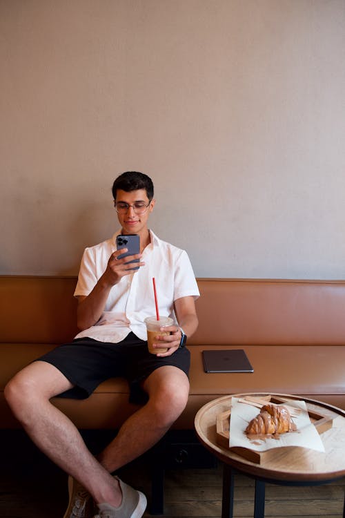 Man Sitting with Cellphone