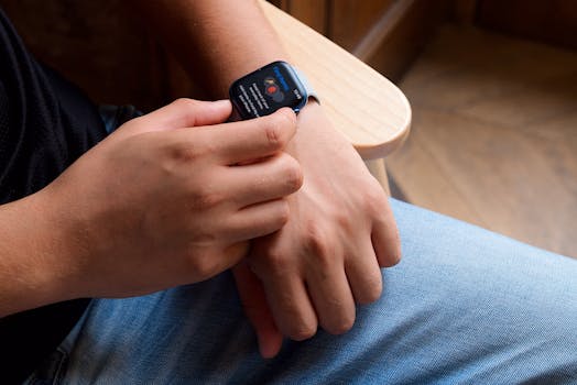 Close-up of a person interacting with a smartwatch, showcasing modern technology and portability.