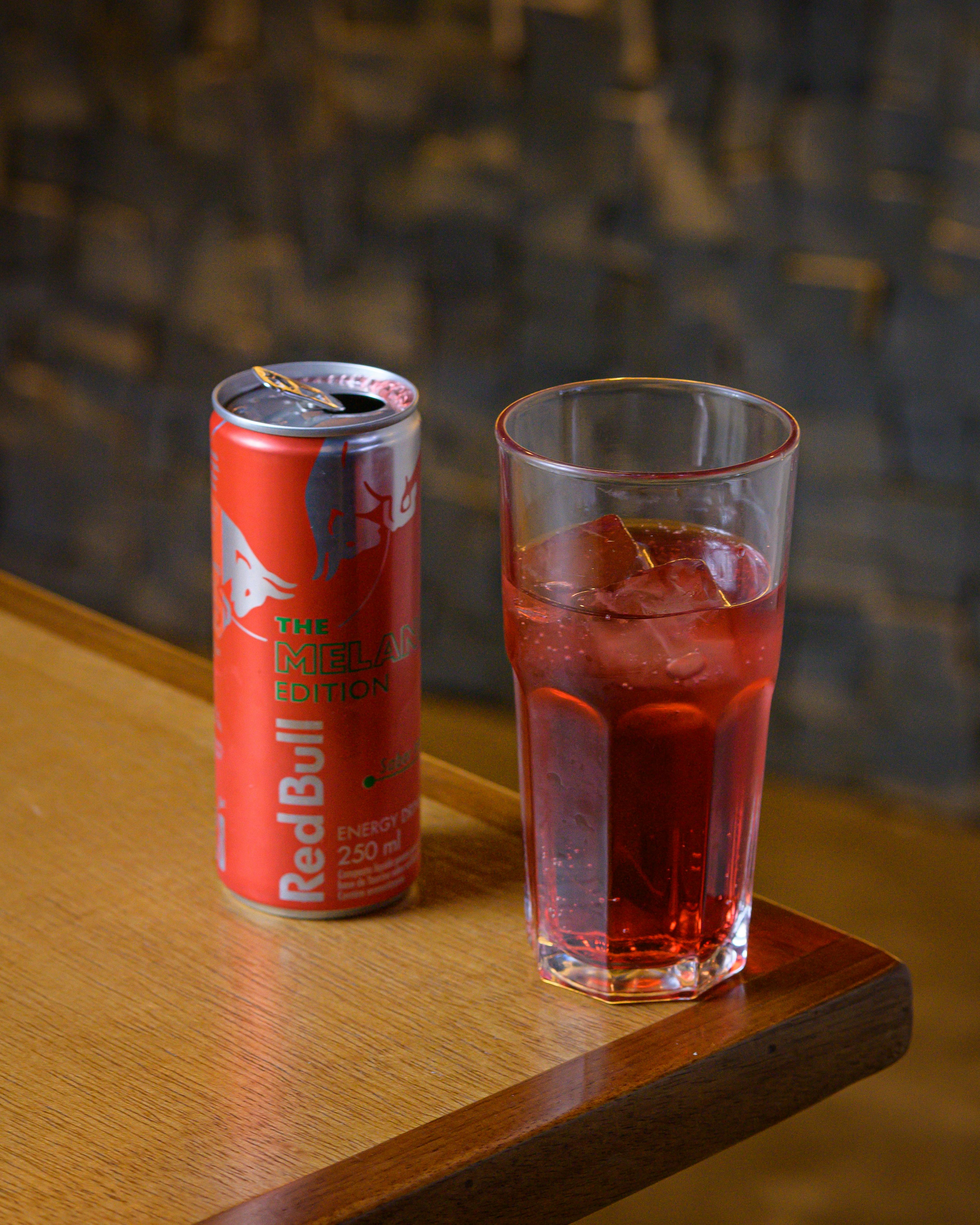 red bull can and glass