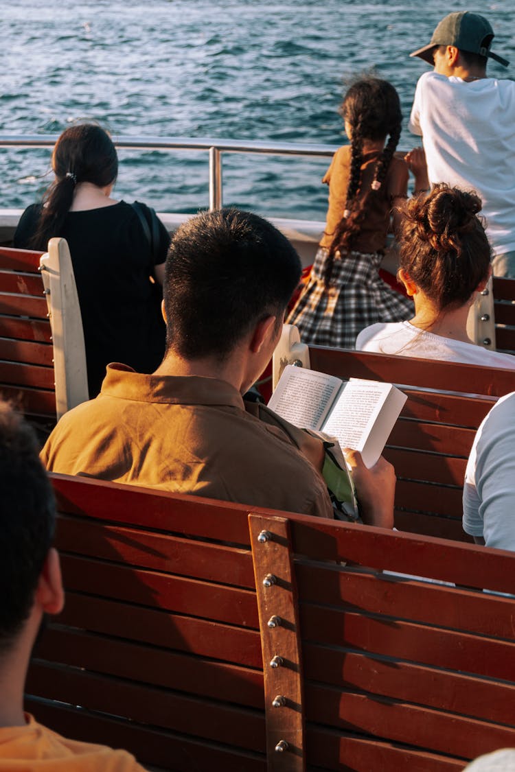 People Sitting And Sailing On Ferry