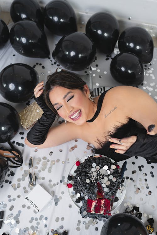 Young Woman Posing at a Birthday Photoshoot with Confetti