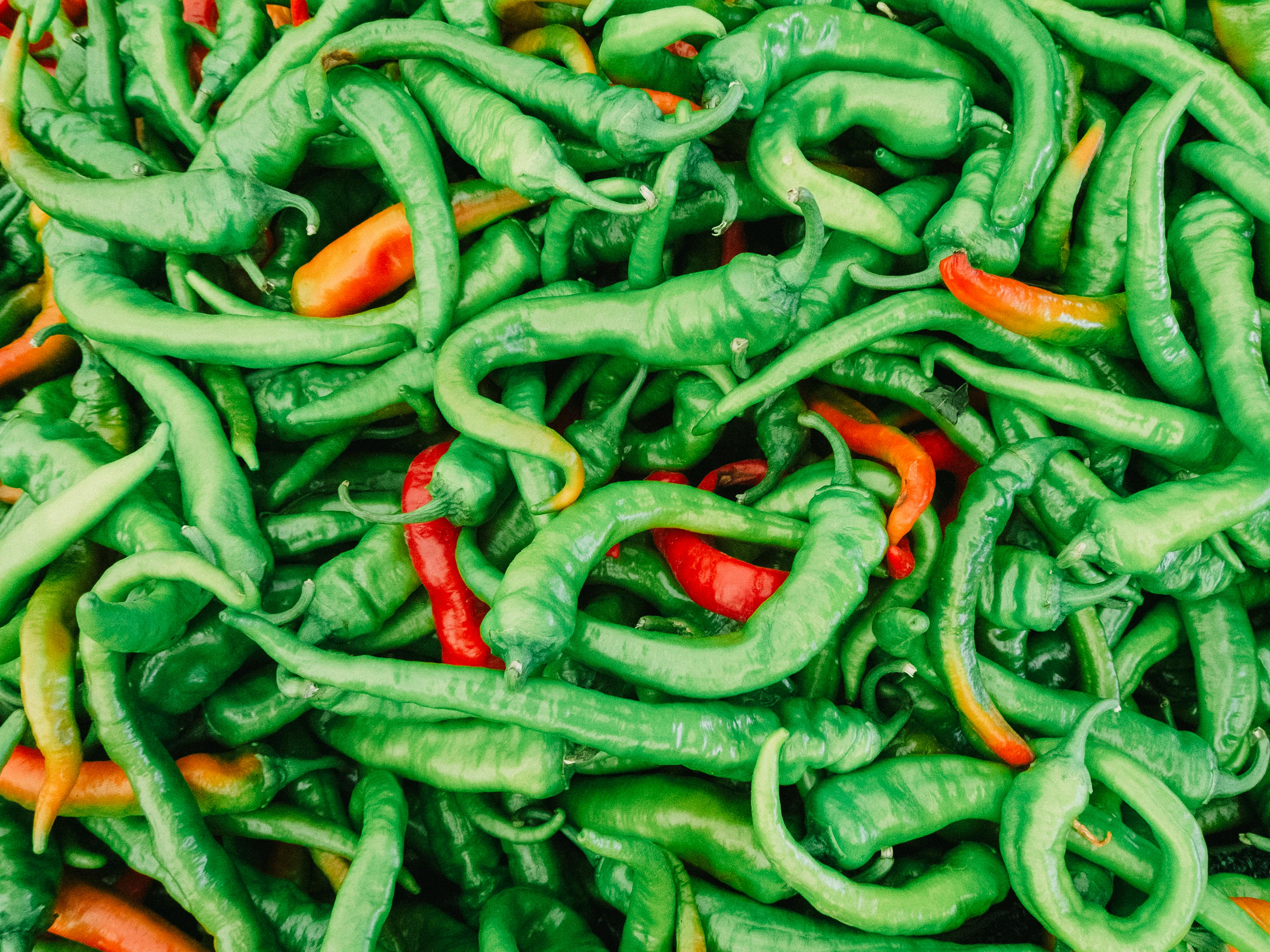 A colorful mix of fresh green and red peppers capturing nature's abundance.