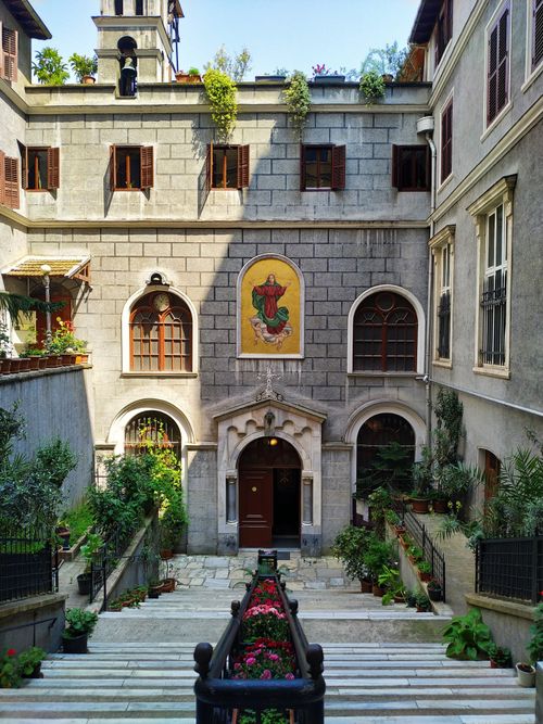 Free Explore the beautiful neoclassical courtyard of Saint Mary Draperis Church in Istanbul, illuminated by warm daylight. Stock Photo