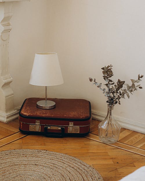 Lamp on Old Suitcase in Room