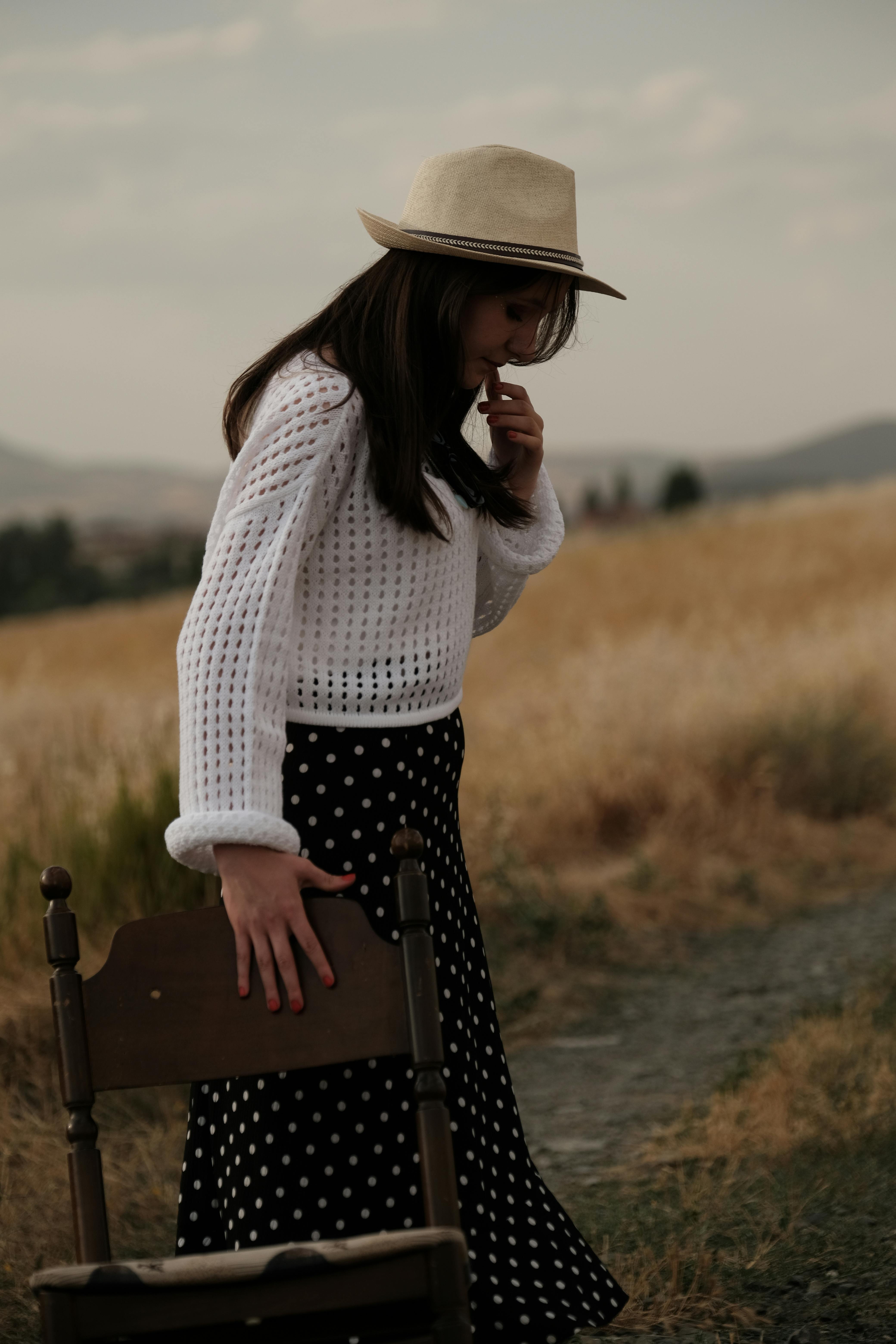 Wide brimmed floppy hat, bra top and asymmetric hem gathered skirt, with  small handbag Stock Photo - Alamy