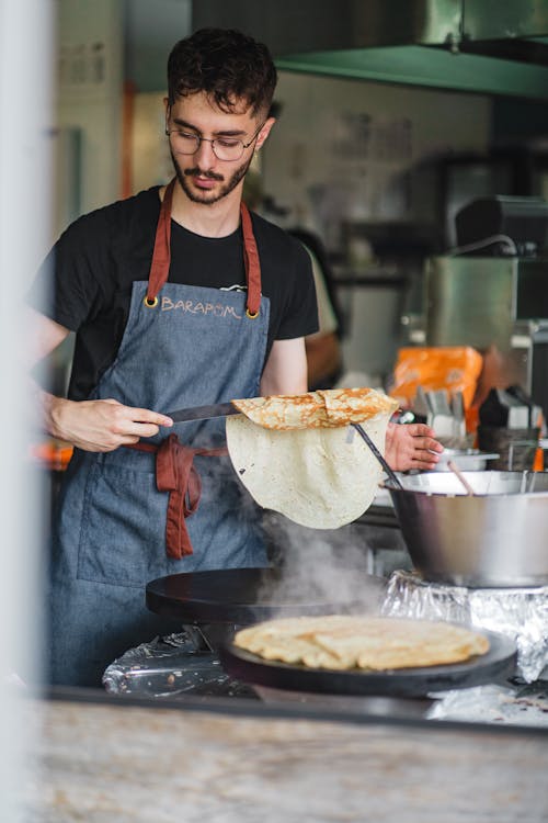 Man Making Pancakes in a Kitchen 