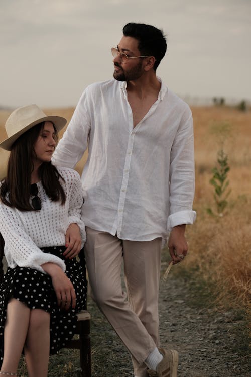 Couple on a Dirt Road Through the Fields on a Summer Day