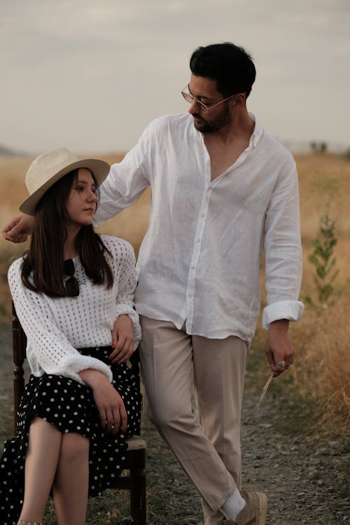 Man Looking at Woman Sitting on Chair