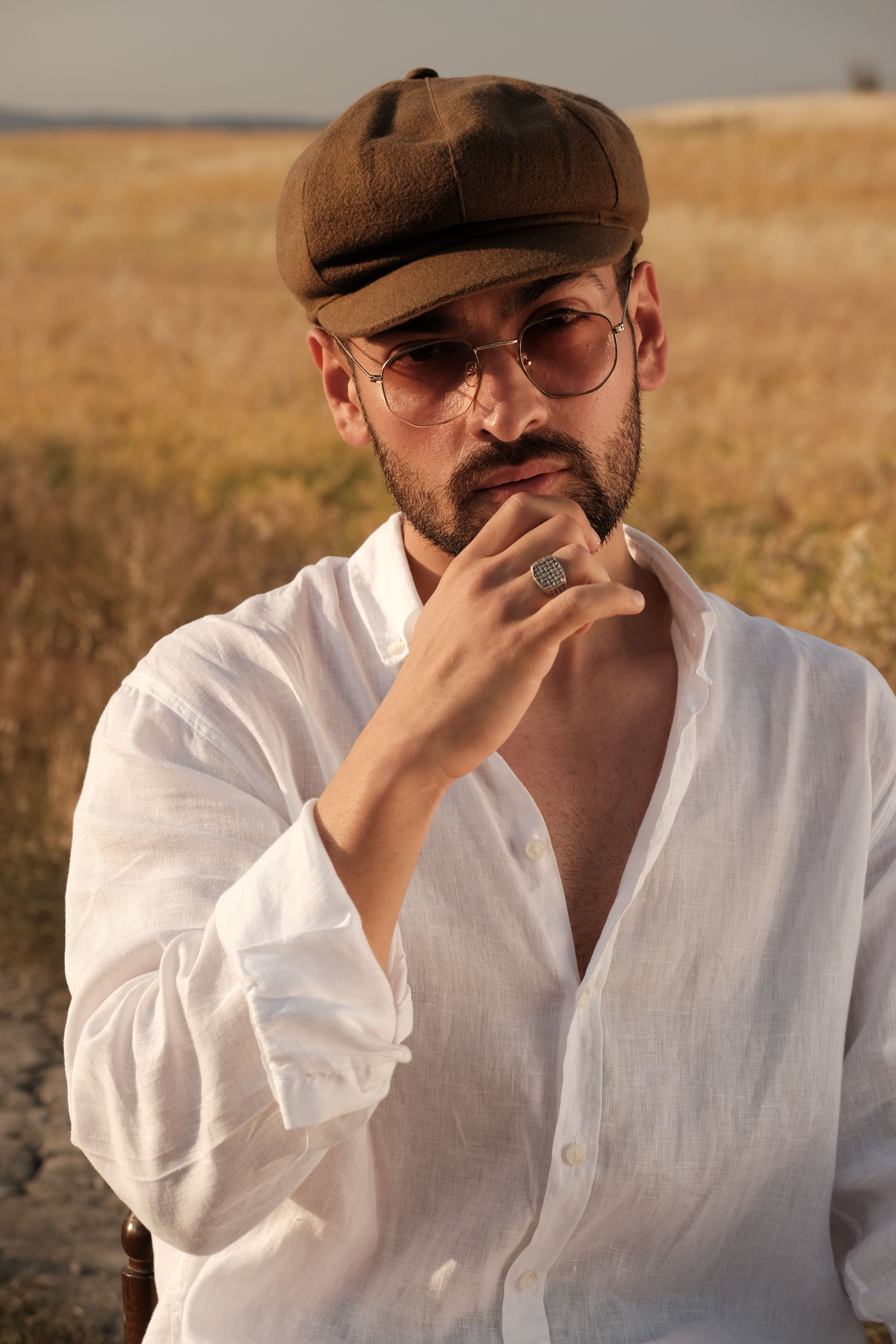 Man in Newsboy Cap and Sunglasses in the Field · Free Stock Photo