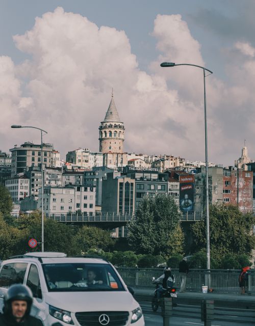 Free View of Galata Tower surrounded by urban Istanbul architecture and busy street. Stock Photo
