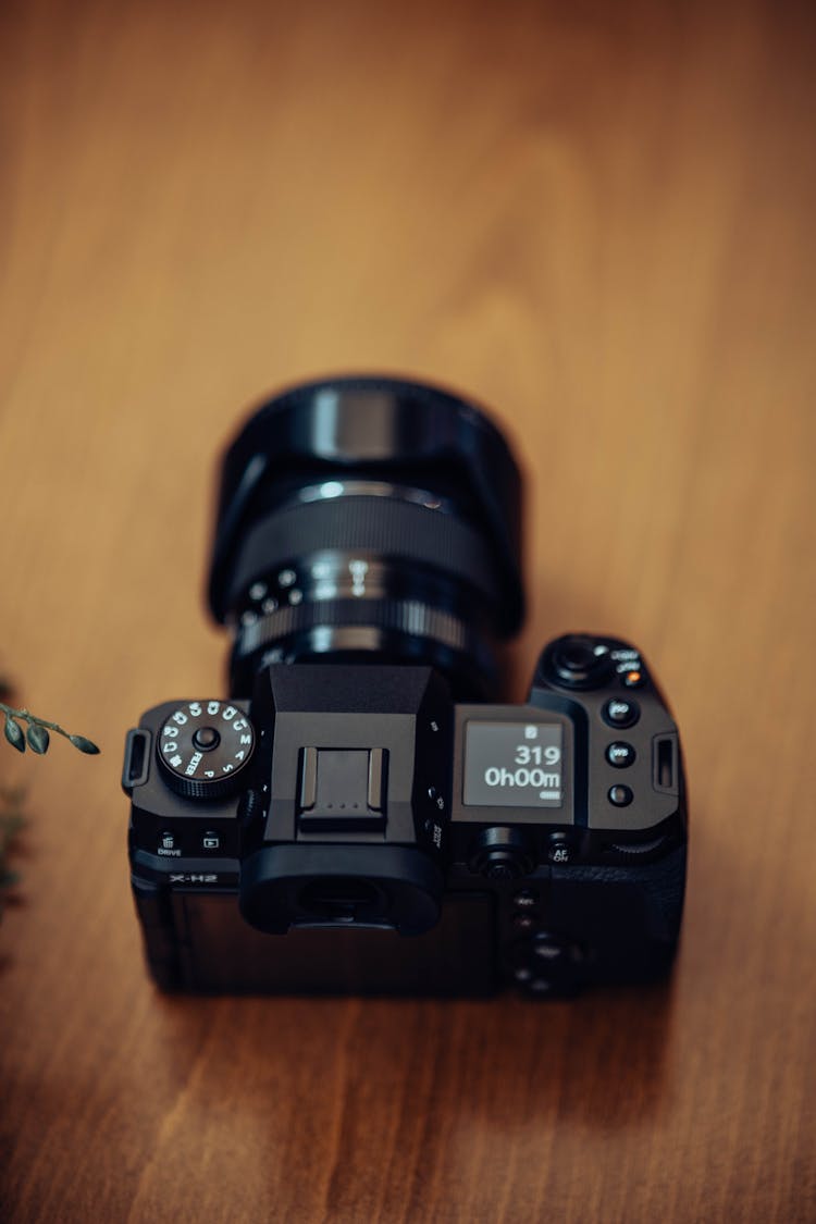 Black Camera On Wooden Table