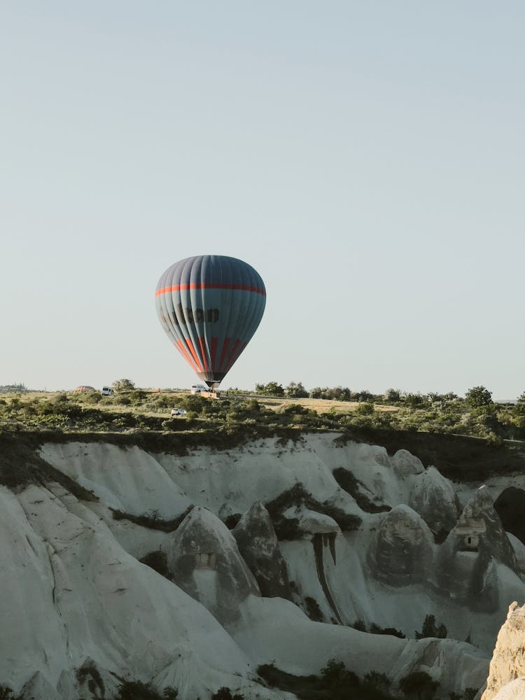 Balloon Floating Over Rock In Cappadocia