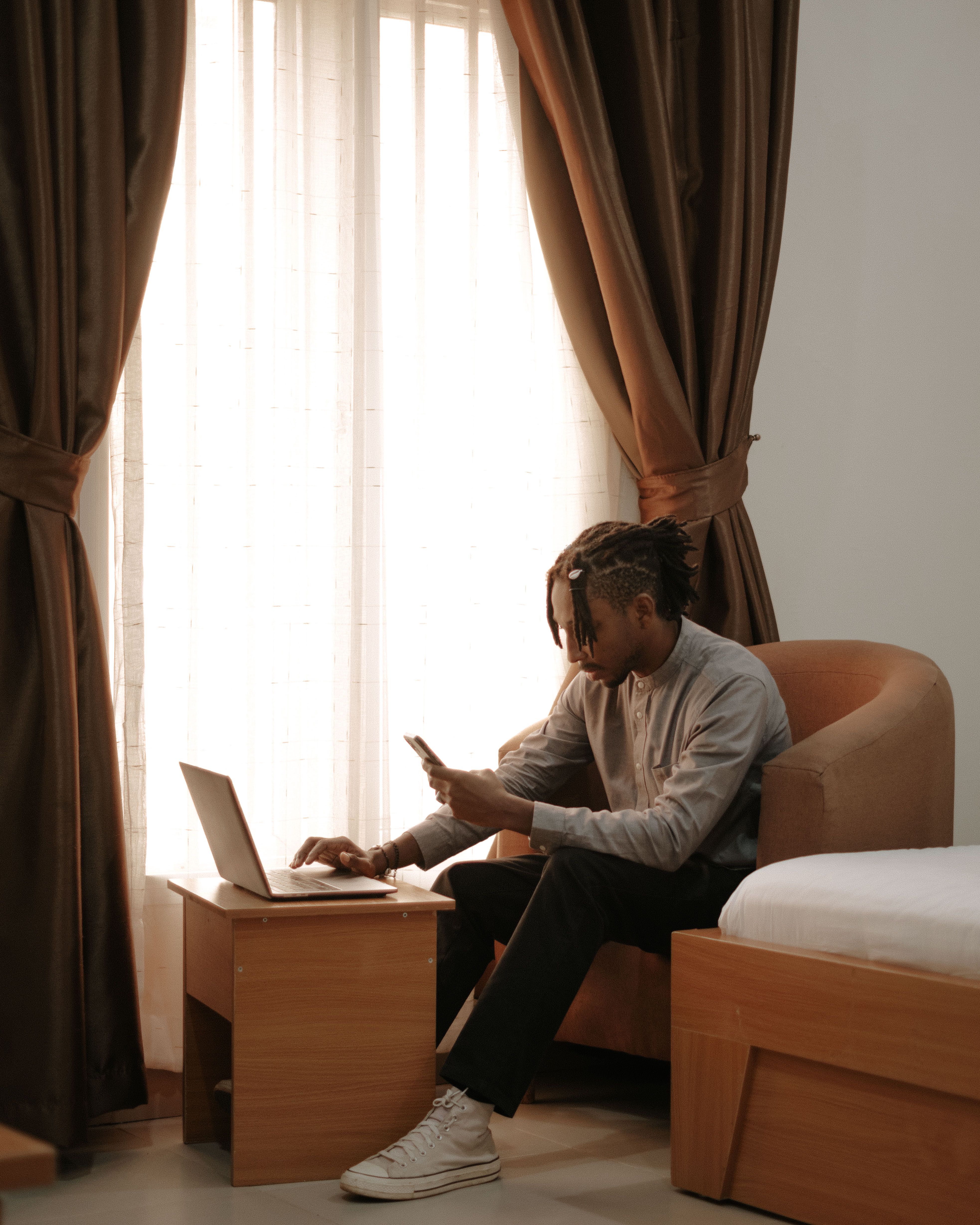 Person rechecking hotel rates on laptop in hotel room