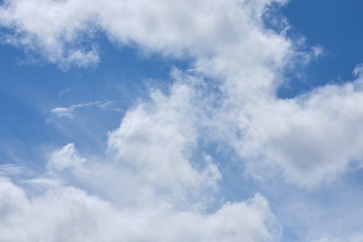 A serene view of fluffy white clouds against a bright blue sky, captured in Penrith, England.