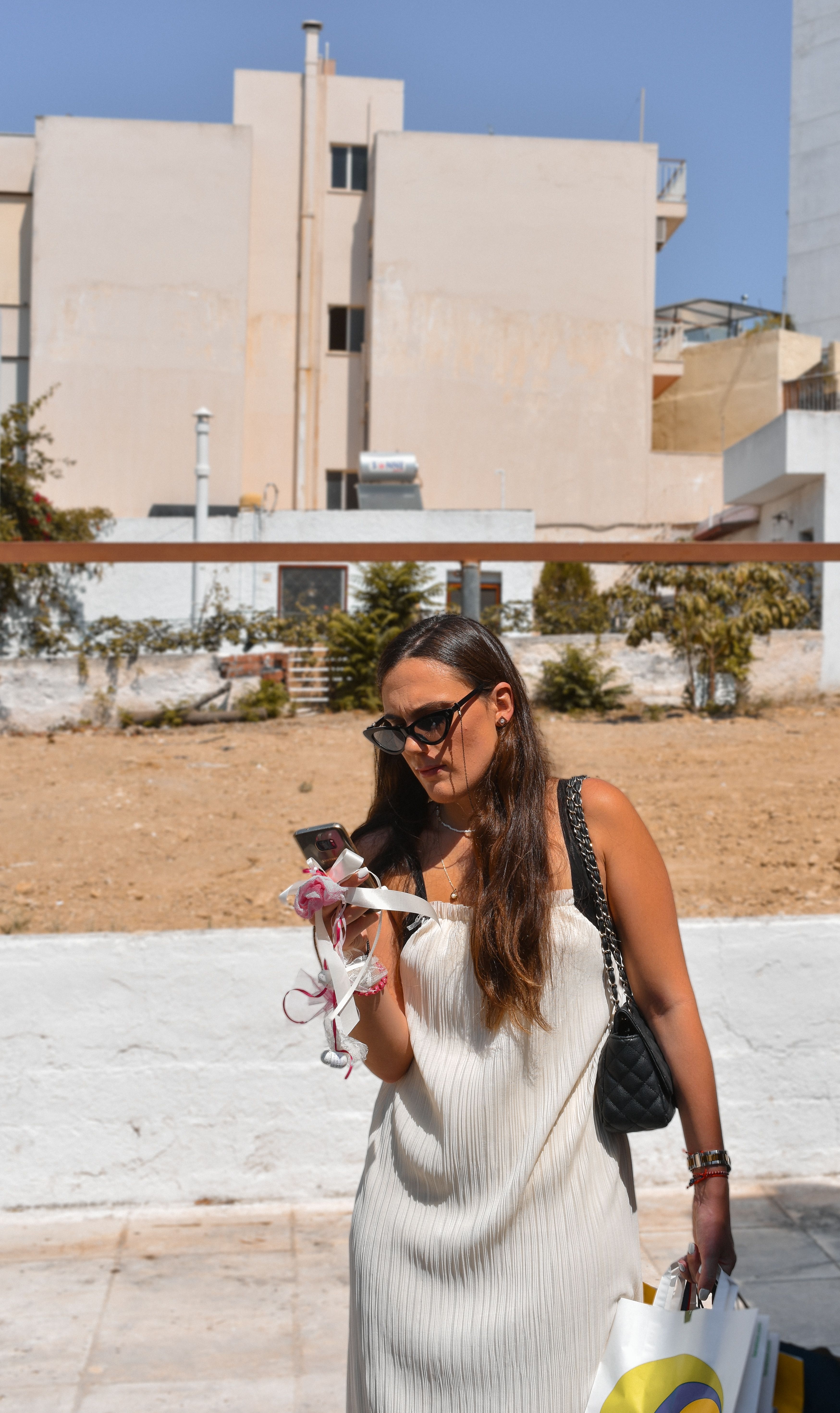 Woman in Athens, Greece, enjoying shopping on a sunny day. Captured outdoors with a modern street style vibe.