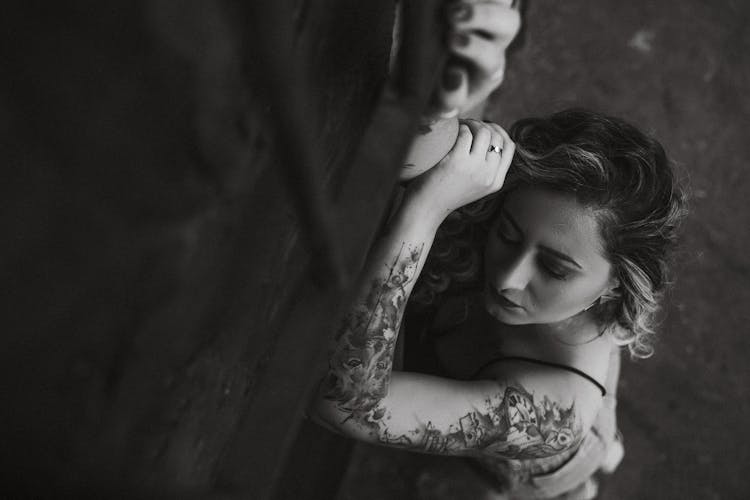 Woman In Tattoos On Arm