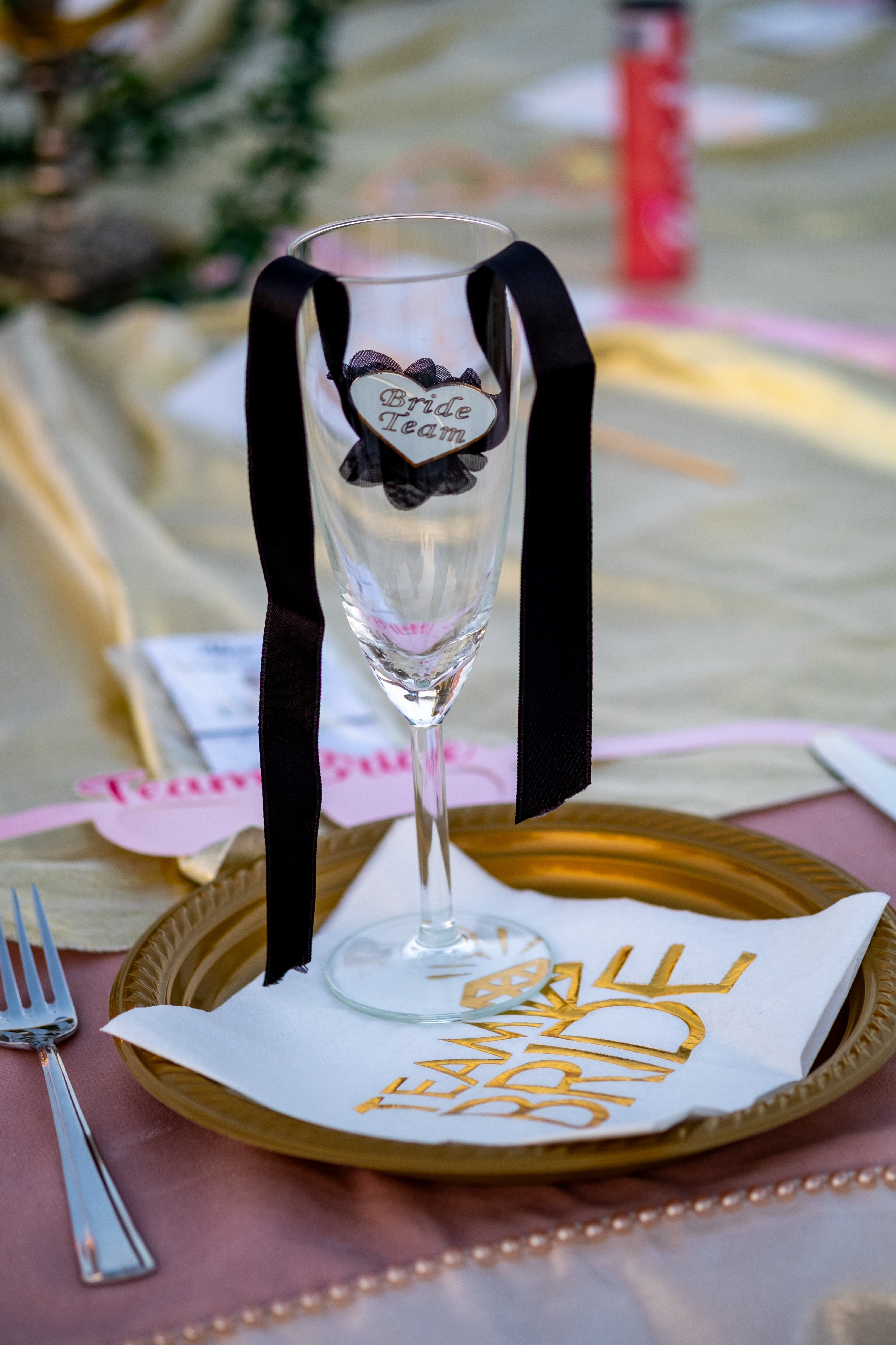 Elegant bridal glass with black ribbon on golden plate, perfect for wedding celebrations.