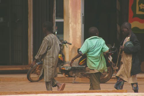 A Group of Kids Walking on the Street 